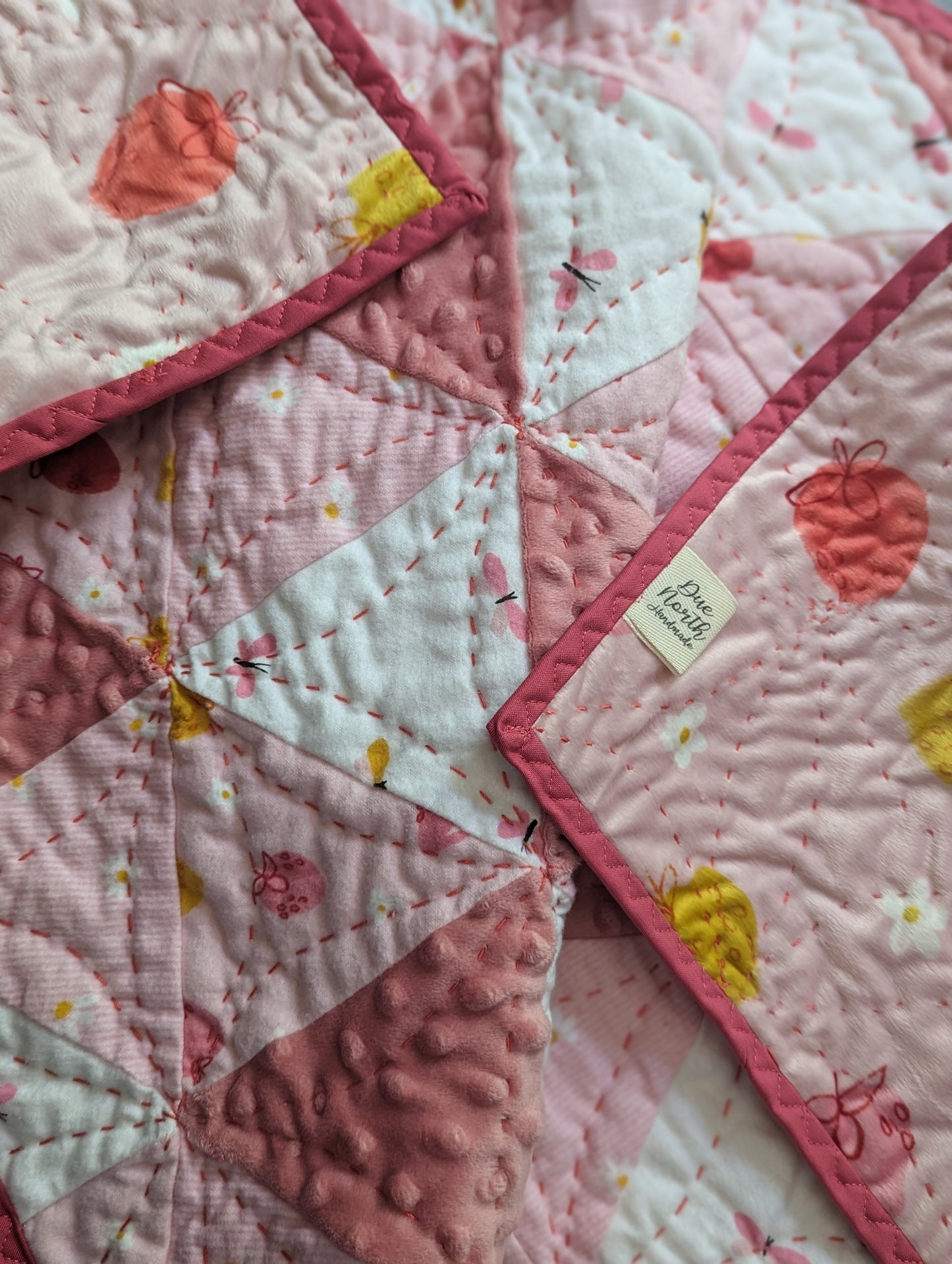 Strawberries and cream hand quilted crib quilt